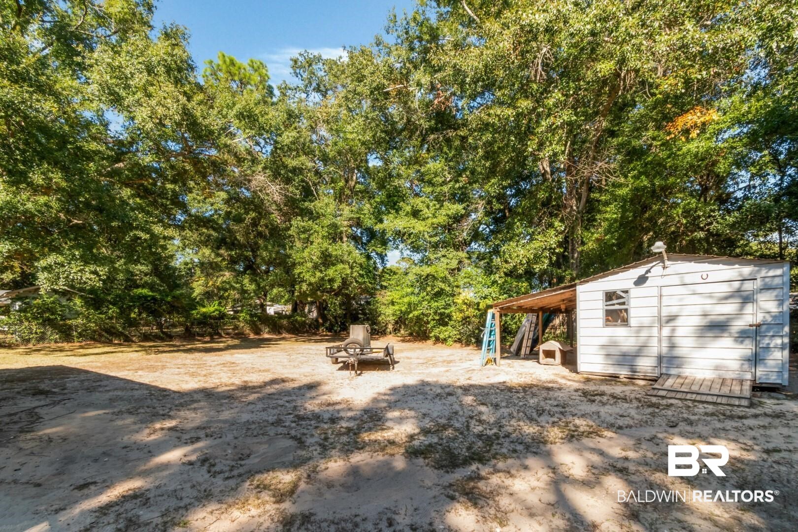 1321 Rainbow Drive West Mobile, AL 36693 - Photo 37 of 48 View of yard featuring a storage unit