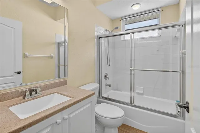 an aerial view of a house with outdoor space and a lake view in back