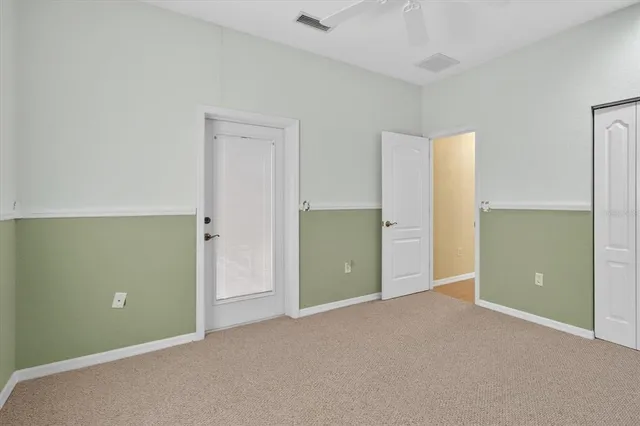 a front view of a house with garden and trees