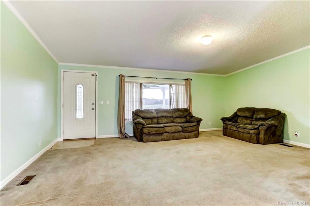4737 White Store Road Wingate, NC 28174 - Photo 14 of 36 a spacious bedroom with a bed and a cabinets