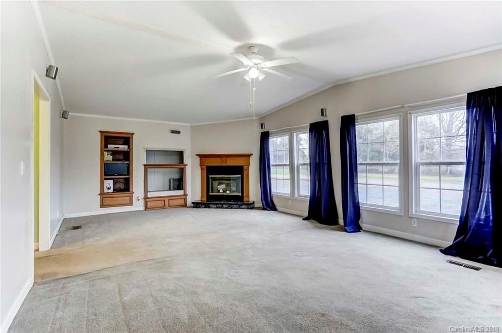 4737 White Store Road Wingate, NC 28174 - Photo 24 of 36 a view of an empty room with a fireplace and a window