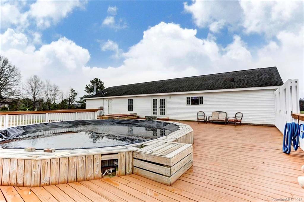 4737 White Store Road Wingate, NC 28174 - Photo 27 of 36 a kitchen with stainless steel appliances granite countertop a stove and a wooden floors