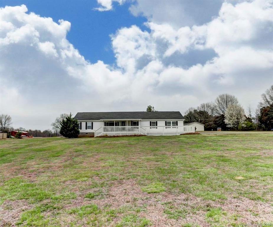 4737 White Store Road Wingate, NC 28174 - Photo 4 of 36 a big yard with lots of buildings in the background