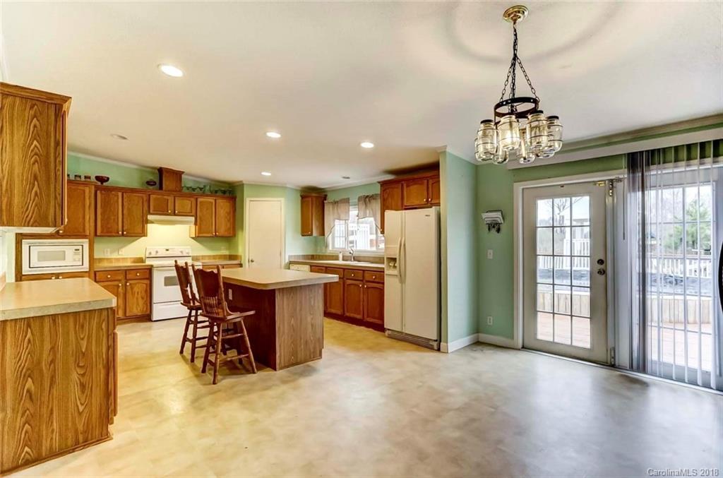 4737 White Store Road Wingate, NC 28174 - Photo 10 of 36 a view of a dining room with furniture window and wooden floor
