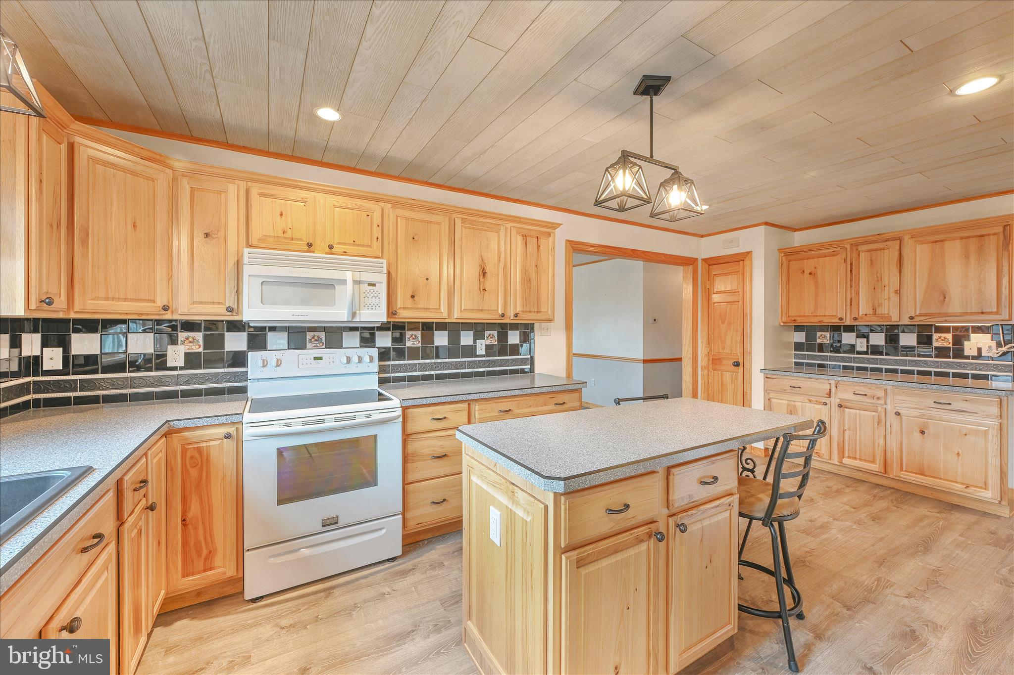 3 Coleman Road Hegins, PA 17938 - Photo 24 of 52 a kitchen with stainless steel appliances granite countertop a stove a sink dishwasher and a refrigerator with wooden cabinets