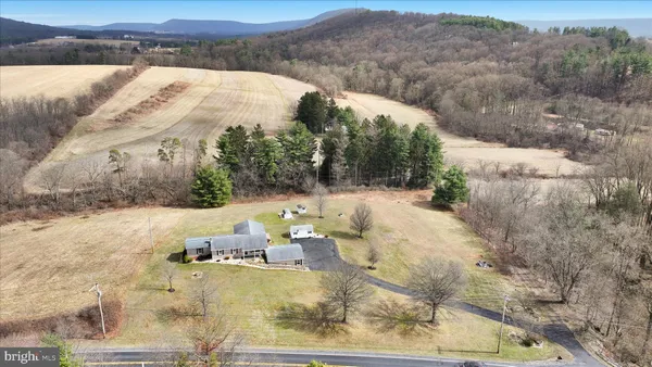 an aerial view of a house with a yard and lake view