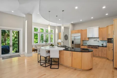 a kitchen with sink and view living room