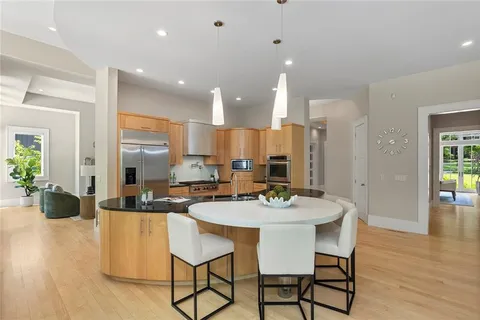 a dining room with furniture a rug and wooden floor