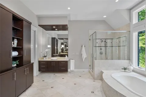 a bathroom with a double vanity sink a mirror and a shower