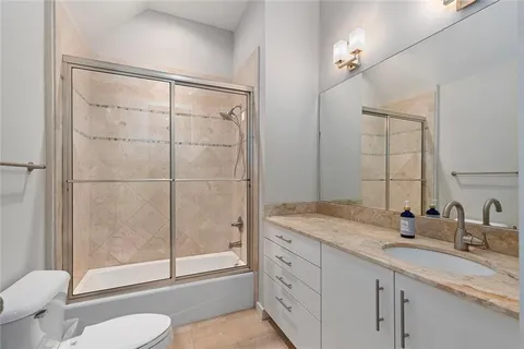 a kitchen with stainless steel appliances a sink a stove a refrigerator and cabinets