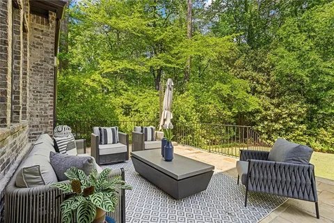 an aerial view of residential house with outdoor space and trees around