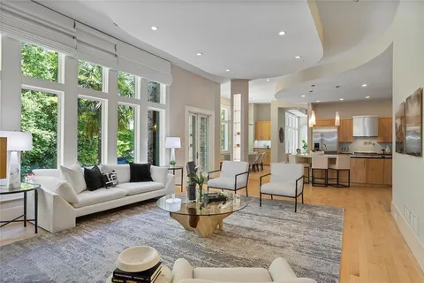 a kitchen with stainless steel appliances granite countertop a refrigerator a stove a sink and white cabinets