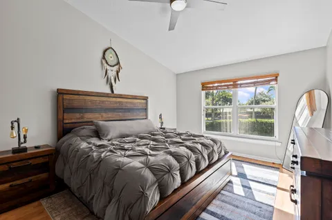 a bedroom with a bed and painting on the wall