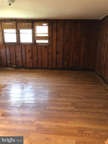 a view of wooden floor with staircase and door