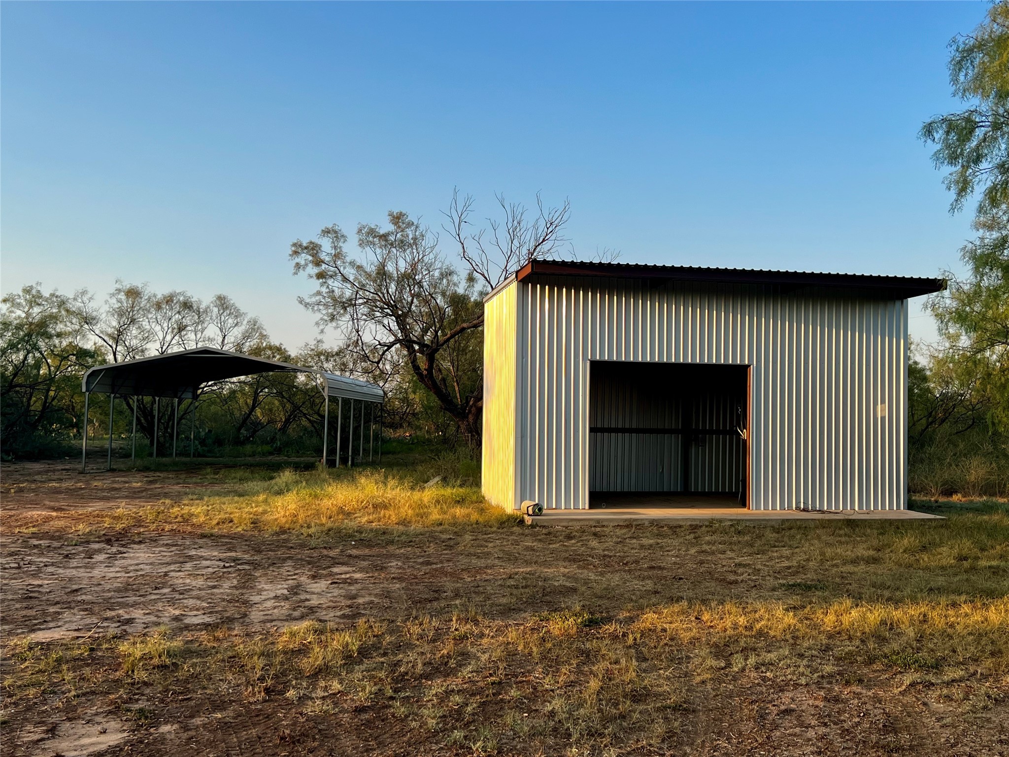 332 Rd Lohn Tx 76852 Road Lohn, TX 76852 - Photo 26 of 37 a front view of a house with a yard and garage