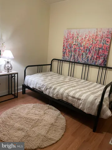 a bed sitting in a bedroom next to a lamp