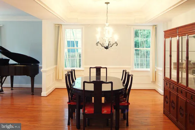 a kitchen with stainless steel appliances kitchen island granite countertop wooden cabinets and a refrigerator