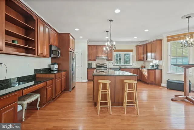 a kitchen with stainless steel appliances a sink stove and cabinets