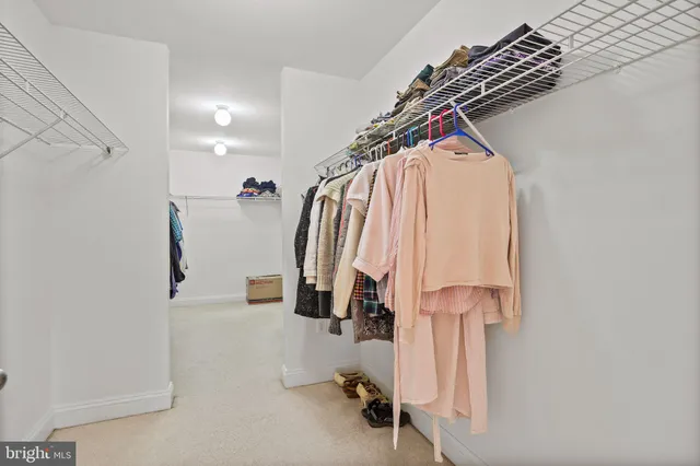 a spacious bedroom with a bed and glass windows