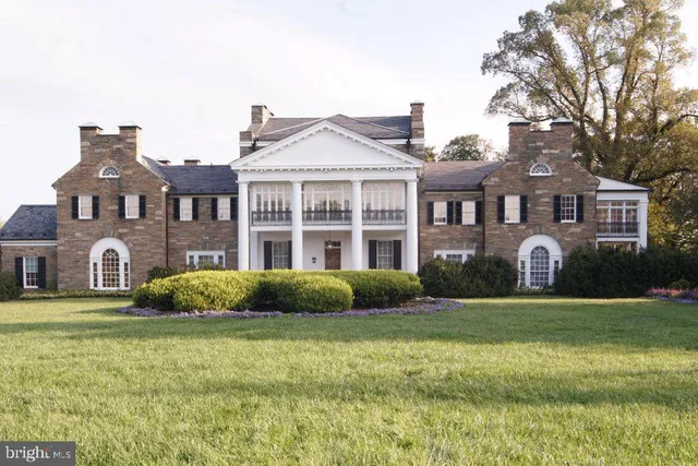 a front view of a house with a yard table and chairs
