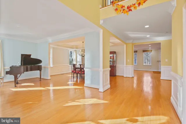 a living room with furniture pool table and a fireplace