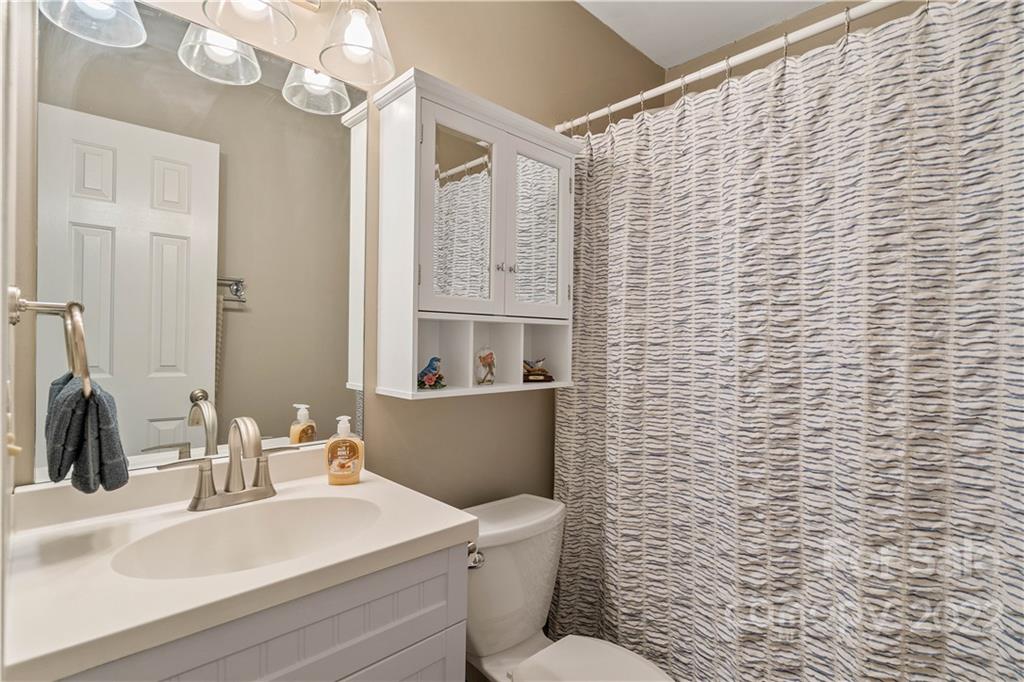 225 Creek View Road Mooresville, NC 28117 - Photo 13 of 18 a bathroom with a sink a toilet and mirror