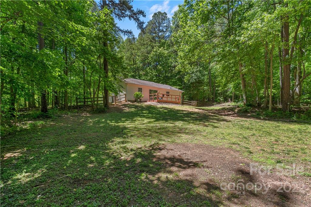 225 Creek View Road Mooresville, NC 28117 - Photo 16 of 18 a backyard of a house with lots of green space