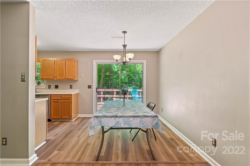 225 Creek View Road Mooresville, NC 28117 - Photo 4 of 18 a dining room with furniture window wooden floor and view