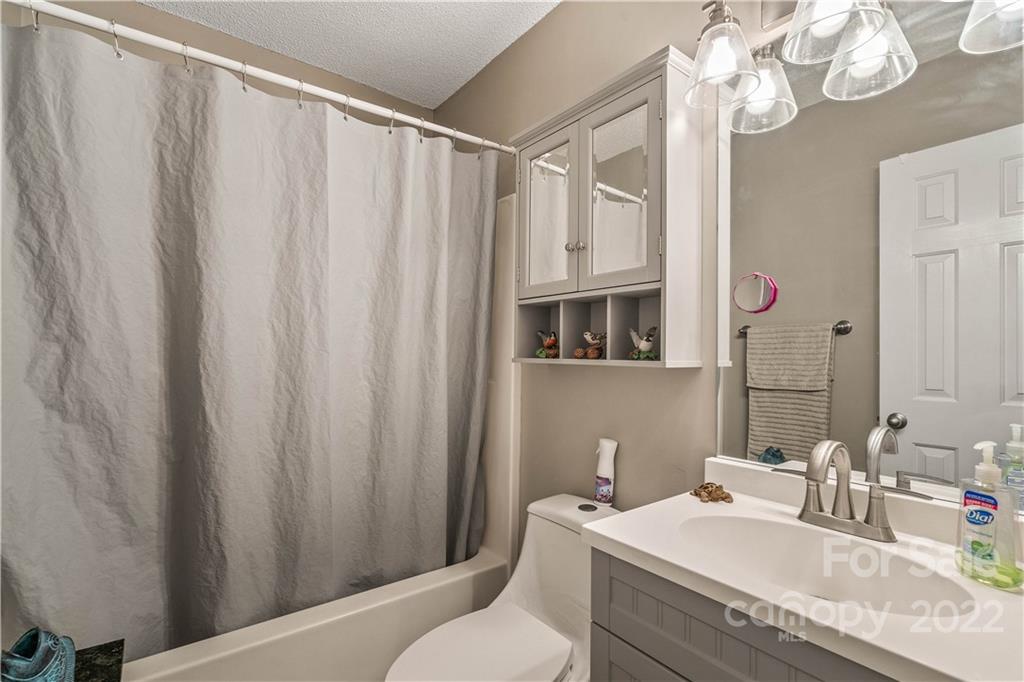 225 Creek View Road Mooresville, NC 28117 - Photo 9 of 18 a bathroom with a granite countertop sink a toilet and a mirror