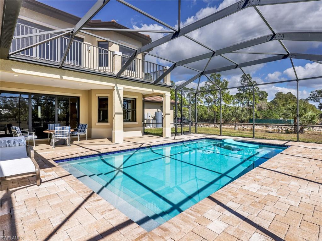 3160 27th Avenue Southwest Naples, FL 34117 - Photo 37 of 43 a view of a patio with a table and chairs under an umbrella