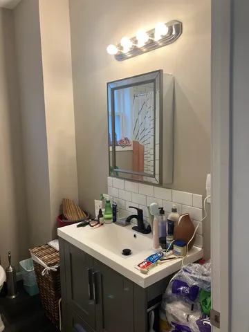 a bathroom with a sink and a mirror