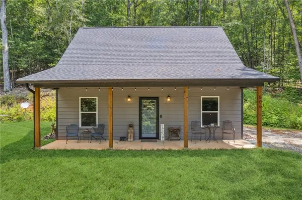 a backyard of a house with table and chairs