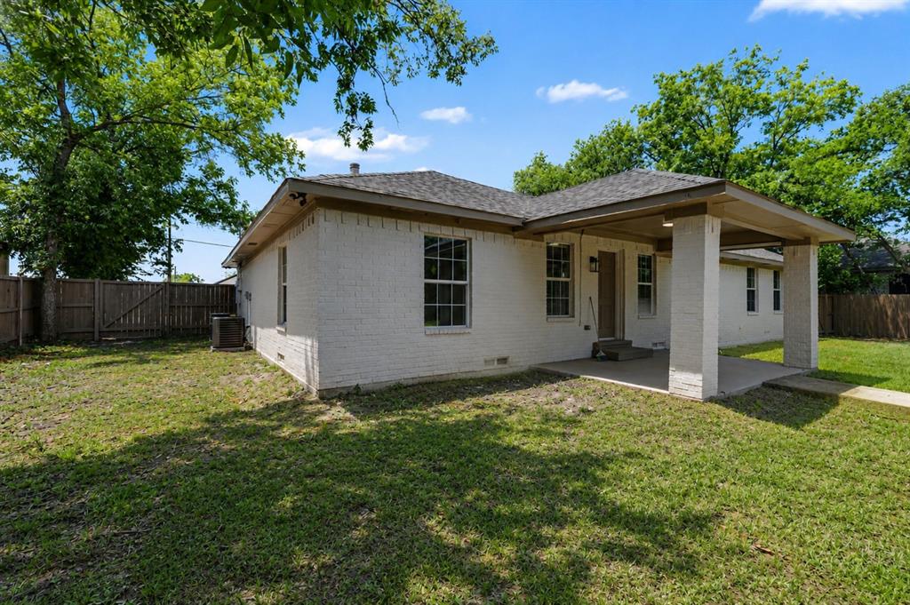 307 Dixon Street Terrell, TX 75160 - Photo 30 of 32 White brick exterior with a covered front porch featuring two columns