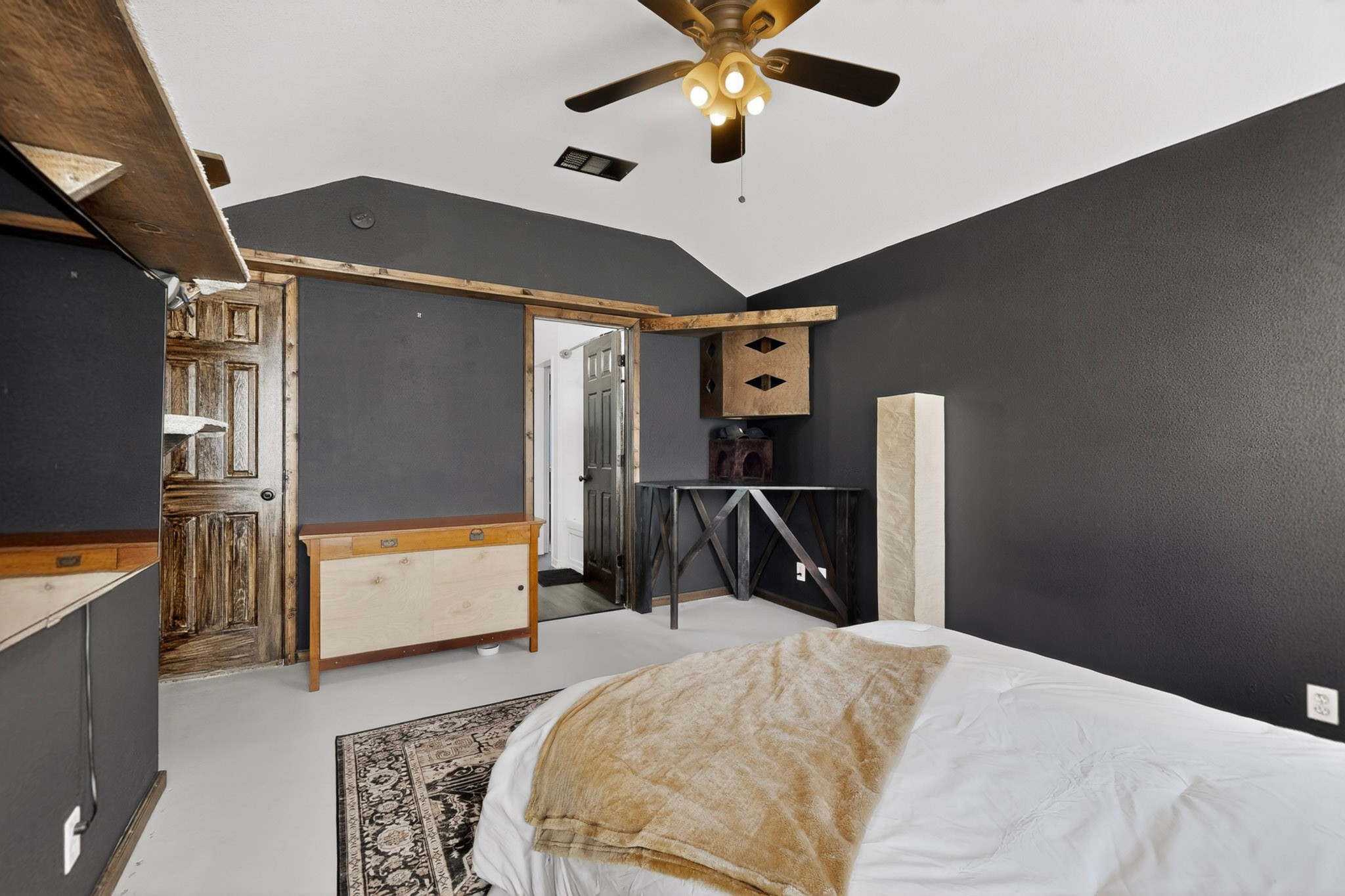 15104 Mimebark Way Austin, TX 78724 - Photo 20 of 38 Vaulted ceiling with a ceiling fan light fixture, dark accent walls, and wood-finish trim