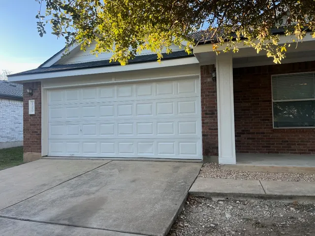 a side view of a house with a garage