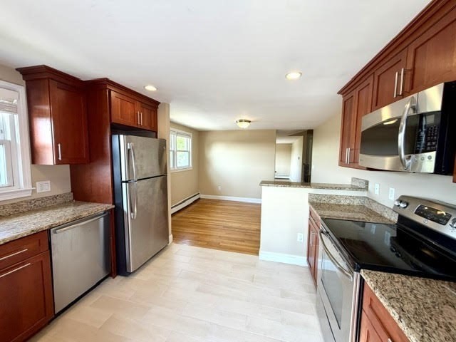 116 Upton Road Waltham, MA 02452 - Photo 4 of 22 a kitchen with stainless steel appliances granite countertop a refrigerator a stove and a sink