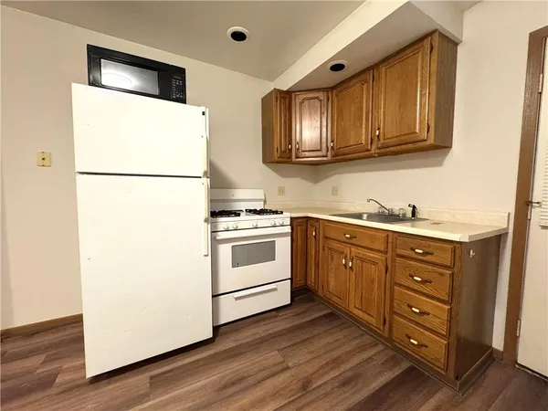 a kitchen with stainless steel appliances a refrigerator sink and cabinets