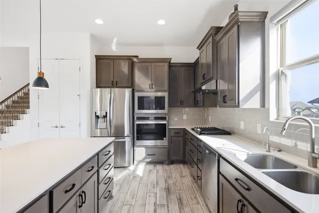 a kitchen with a sink stove and refrigerator