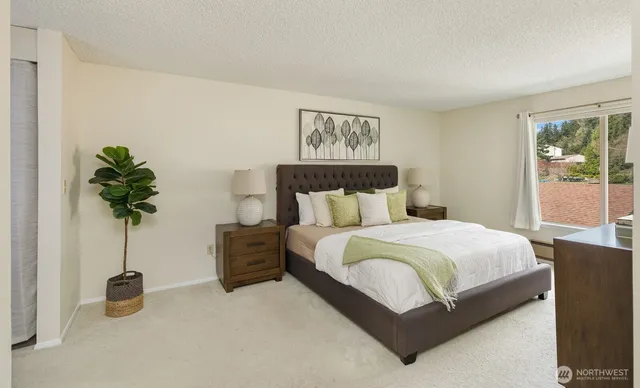 a bedroom with a bed and a potted plant