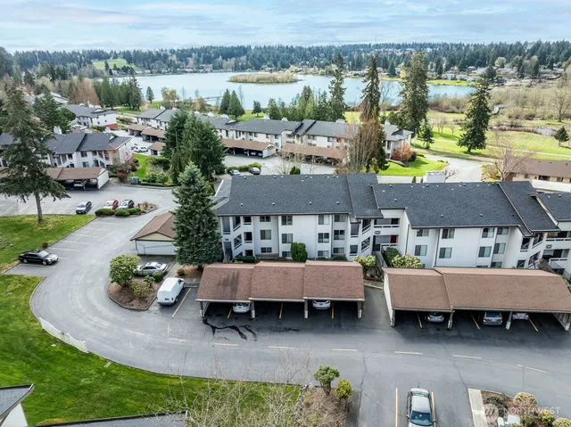 an aerial view of a house with a garden and lake view