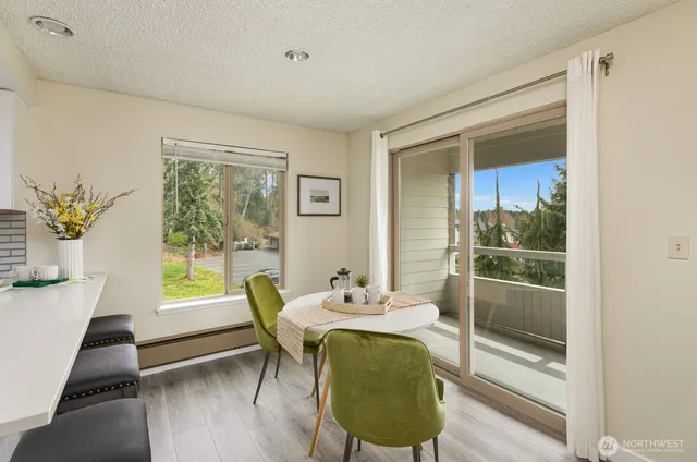 a view of a dining room with furniture window and wooden floor