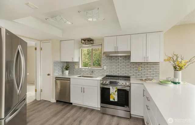 a kitchen with a stove sink and refrigerator