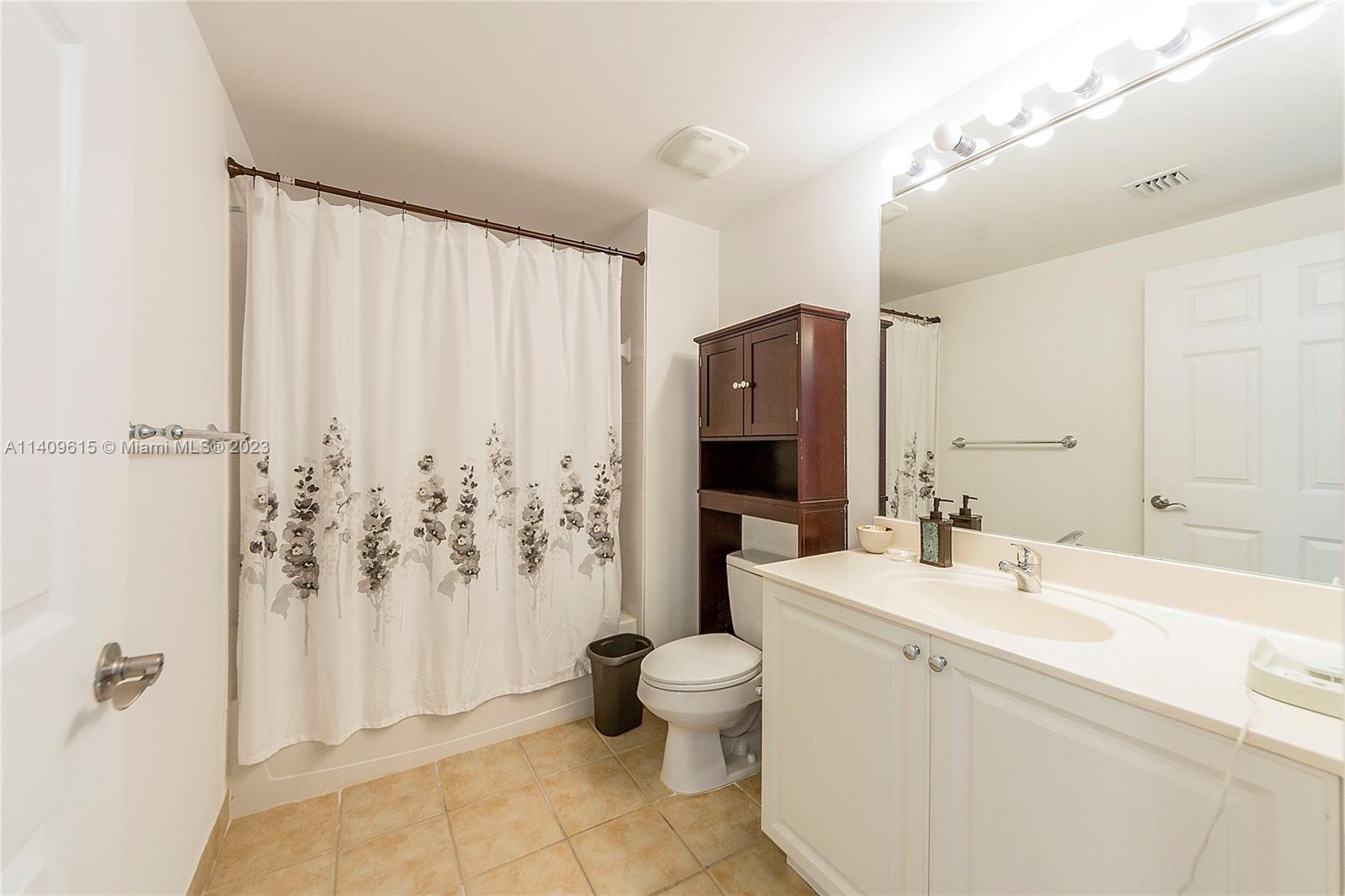 888 Douglas Road, Unit 1407 Coral Gables, FL 33134 - Photo 8 of 11 a bathroom with a sink toilet and shower