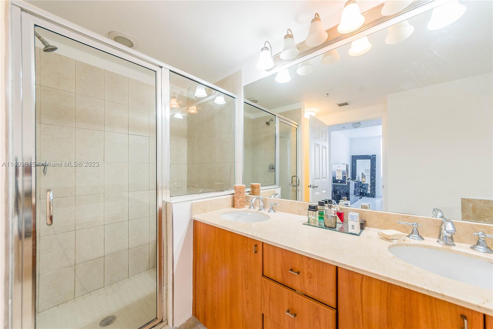 888 Douglas Road, Unit 1407 Coral Gables, FL 33134 - Photo 9 of 11 a bathroom with a granite countertop sink mirror and double