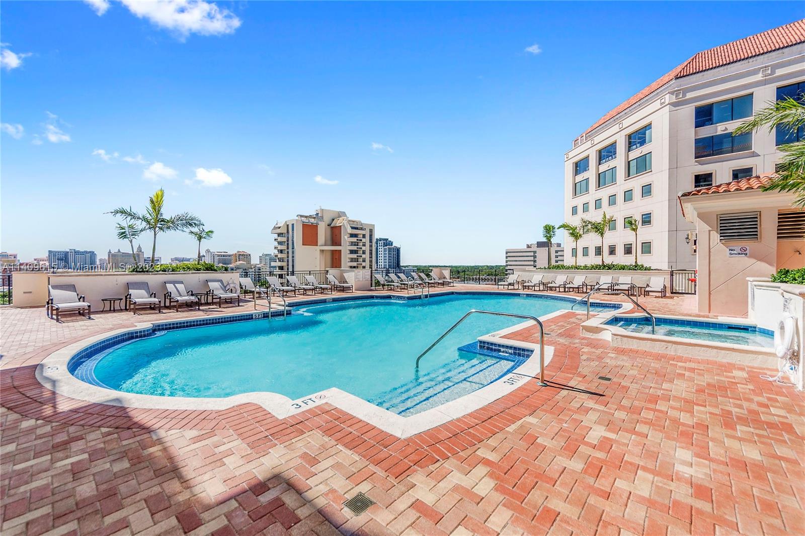 888 Douglas Road, Unit 1407 Coral Gables, FL 33134 - Photo 10 of 11 a swimming pool with outdoor seating and yard