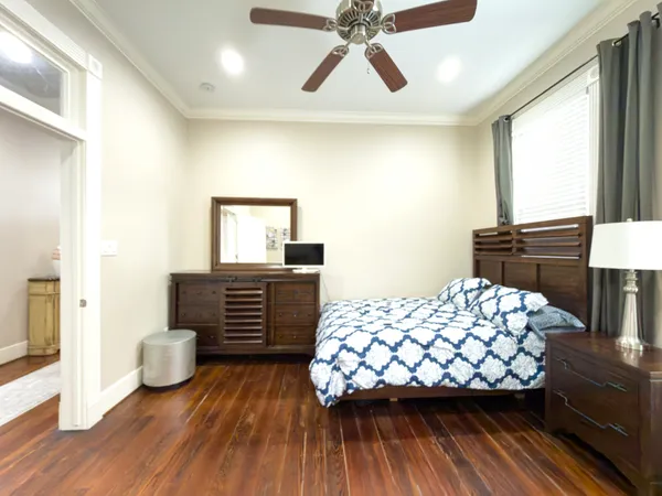 a bedroom with a bed and wooden floor