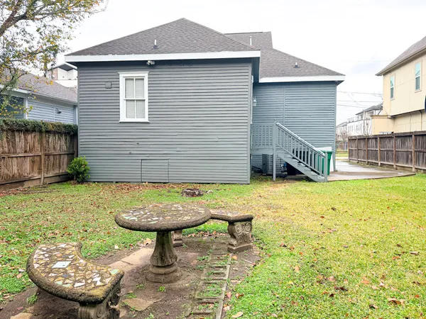 a view of a backyard with table and chairs