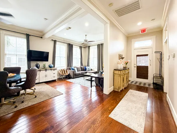 a living room with furniture window and a flat screen tv