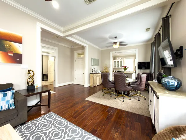 a living room with furniture and a wooden floor
