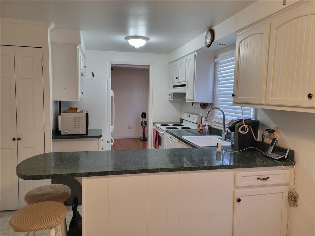 117 Farmington Drive Butler, PA 16001 - Photo 8 of 36 Kitchen Peninsula With Counter Space, Extra Eating Space, and Storage on the Other Side.